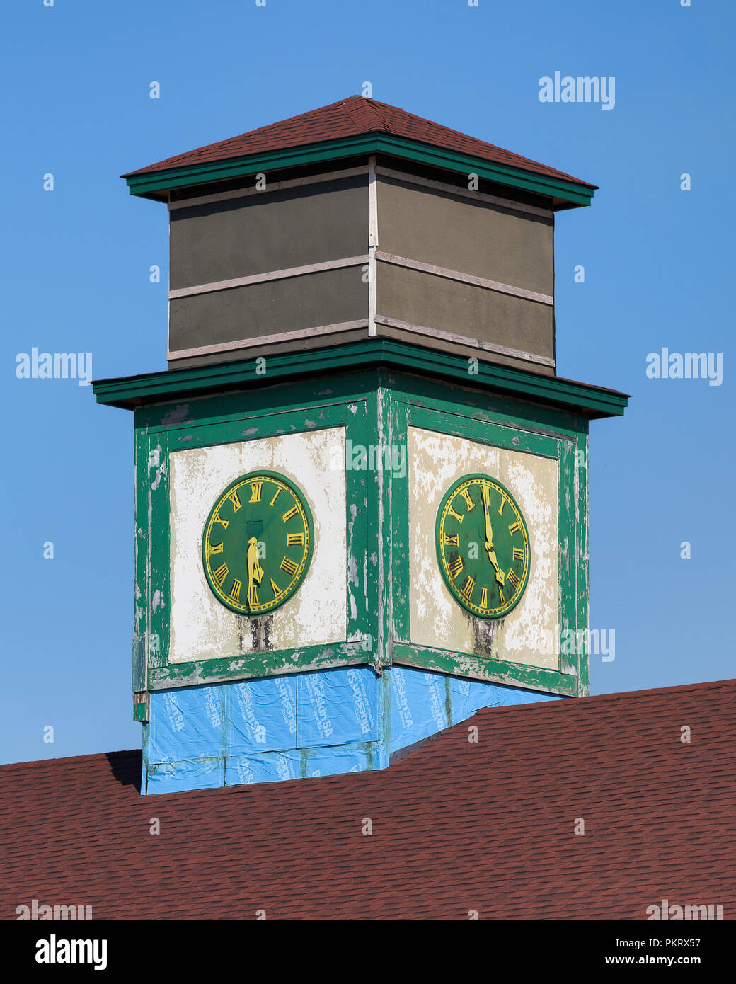 Old green and yellow clock in St. Anthony, Newfoundland and Labrador