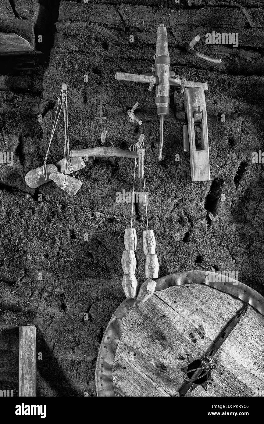 Vikiing tools hanging on wall inside reconstructed sod building in L'Anse aux Meadows, Newfoundland Stock Photo