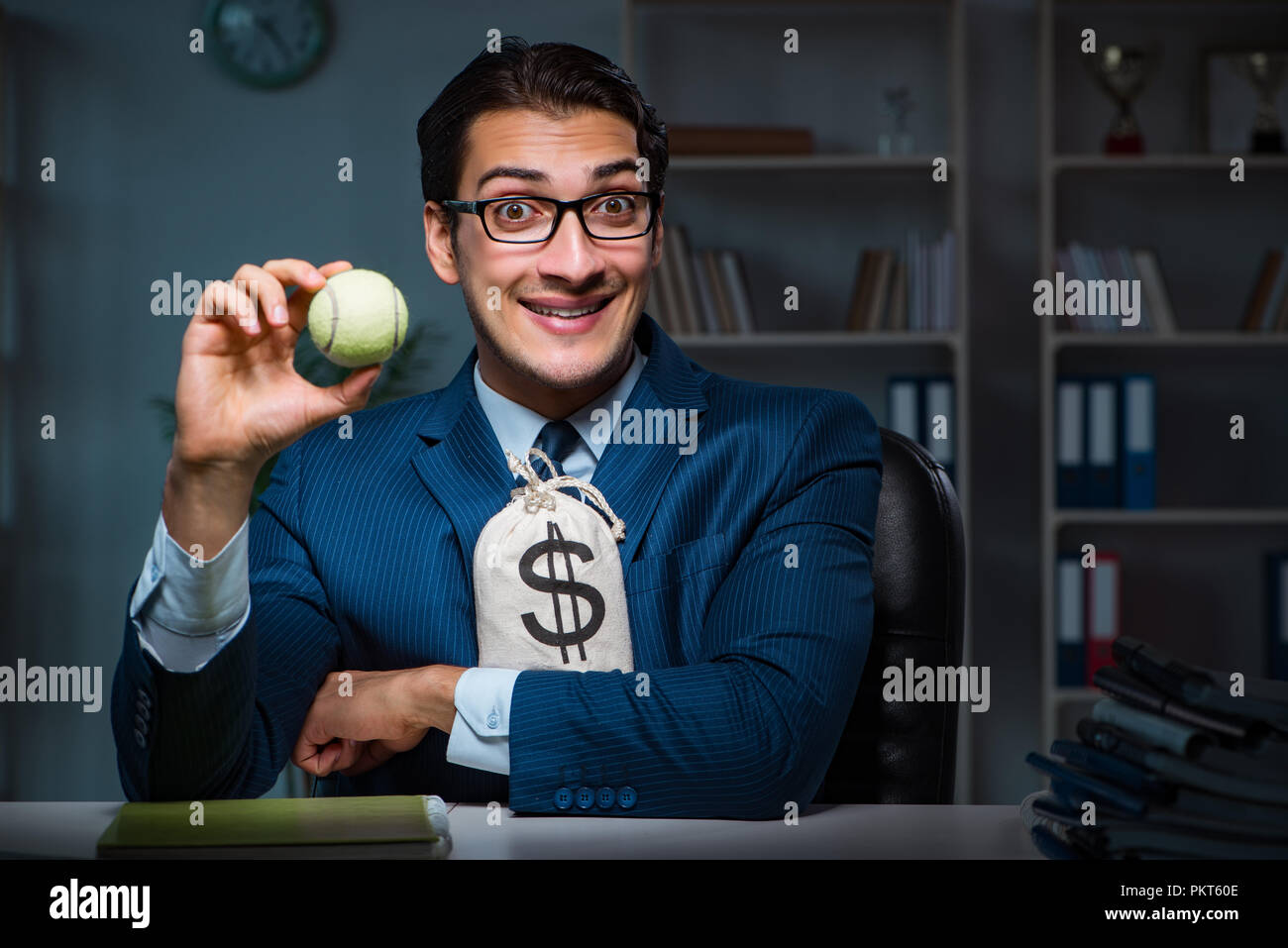 Young employee with tennis ball Stock Photo Alamy