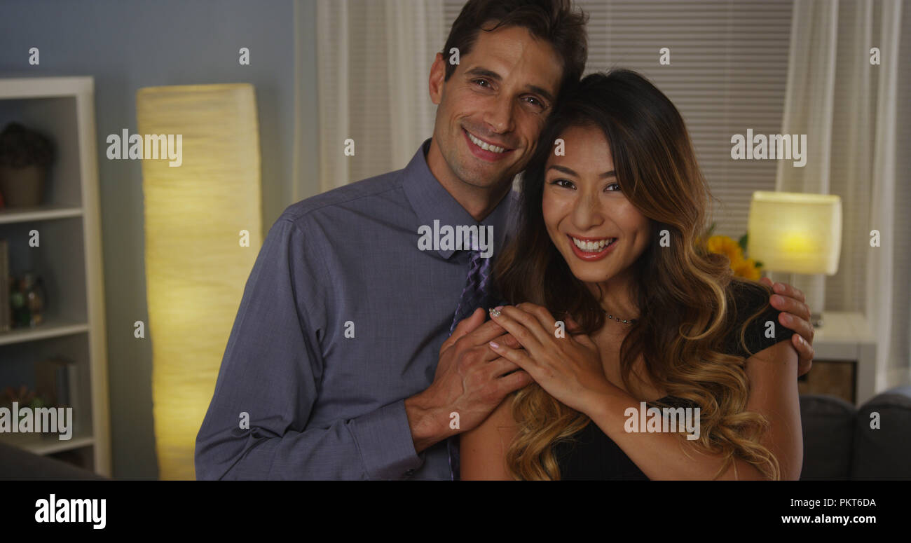 Happy interracial couple smiling at camera Stock Photo