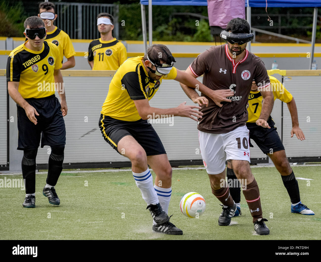 15 September 2018, Hamburg: Serdal Celebi (r), FC St. Pauli footballer for the blind, plays a ball at the 11th Blind Football Masters on the grounds of the Bildungszentrum für Blinde und Sehbehinderte am Borgweg. Celebi is the first blind football player to be nominated for the 'Goal of the Month' of the ARD sports show. Photo: Axel Heimken/dpa Stock Photo
