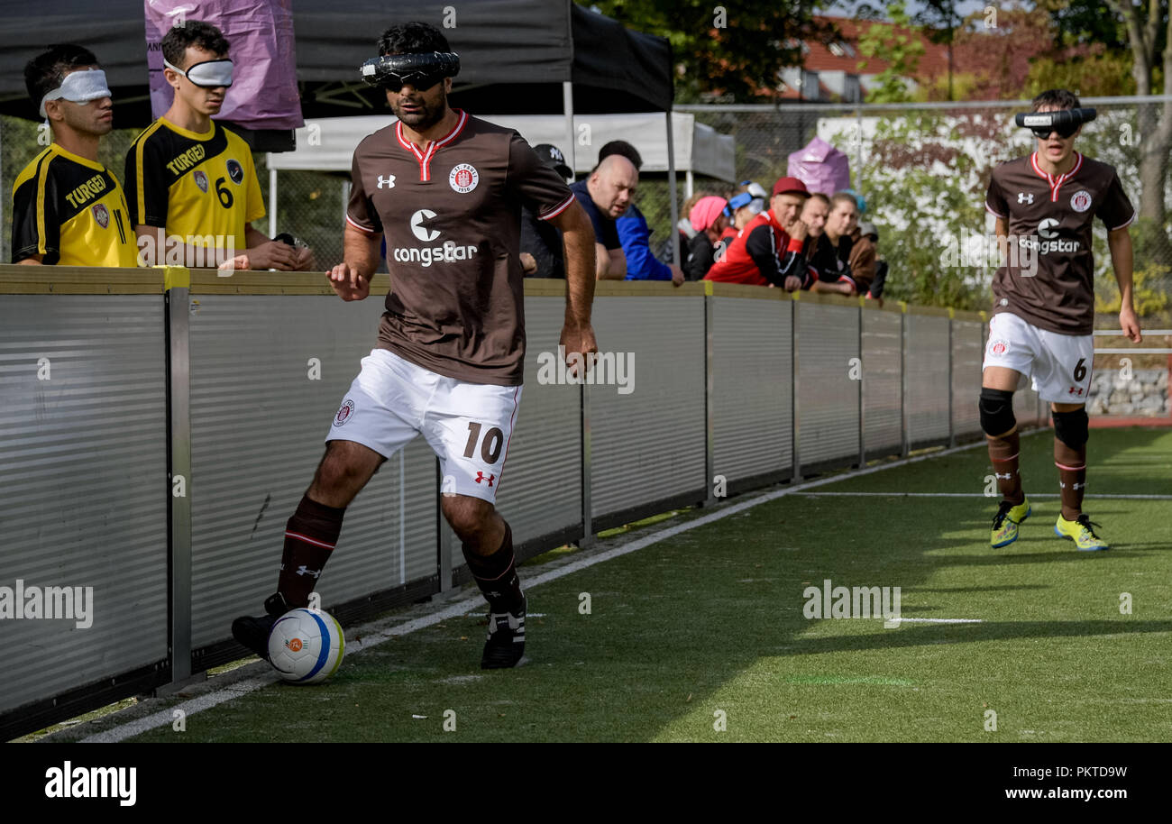 15 September 2018, Hamburg: Serdal Celebi (l), FC St. Pauli footballer for the blind, plays at the 11th Blind Football Masters on the grounds of the Bildungszentrum für Blinde und Sehbehinderte am Borgweg. Celebi is the first blind football player to be nominated for the 'Goal of the Month' of the ARD sports show. Photo: Axel Heimken/dpa Stock Photo