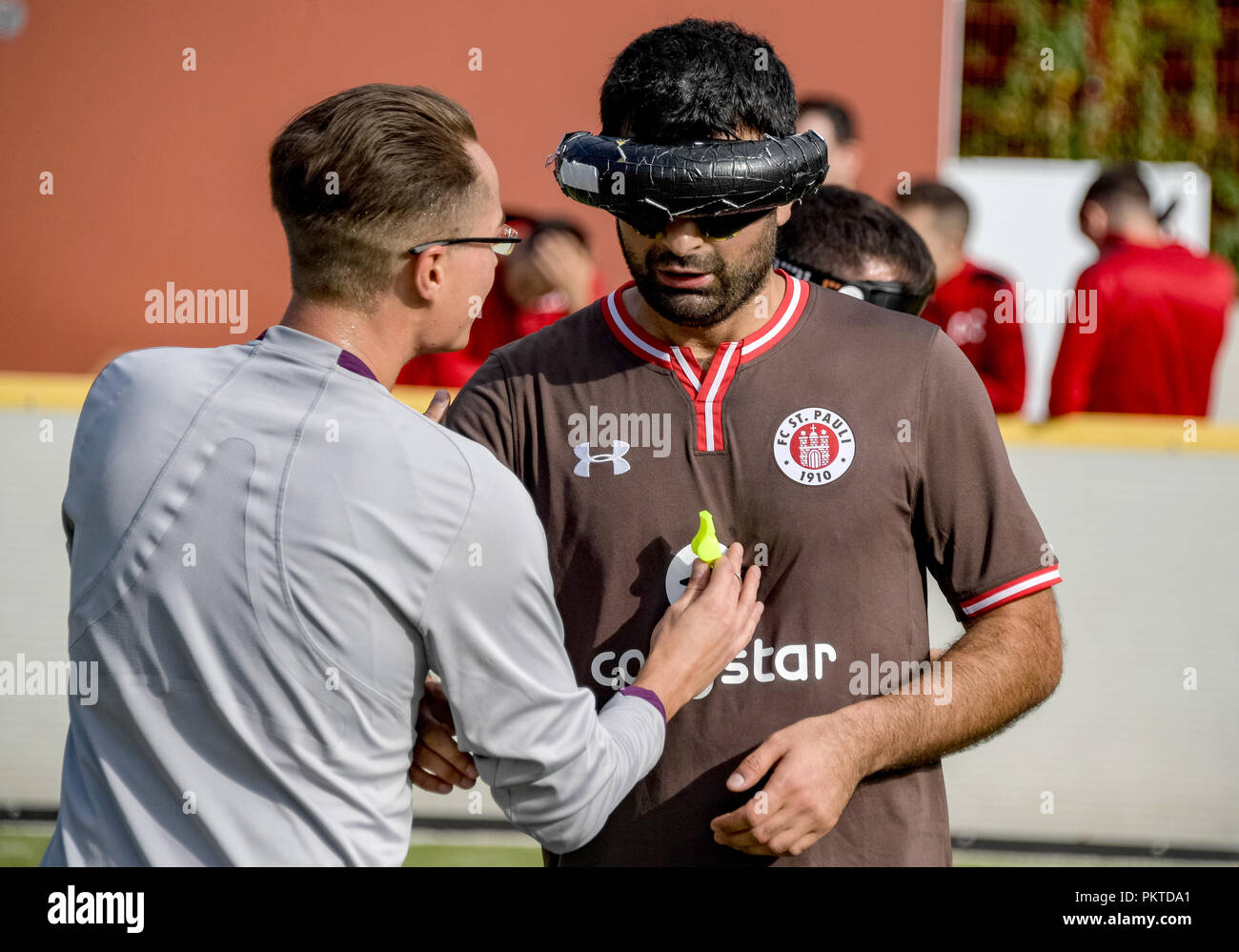15 September 2018, Hamburg: Serdal Celebi (r), FC St. Pauli footballer for the blind, speaks to the referee at the 11th Masters on the grounds of the Bildungszentrum für Blinde und Sehbehinderte on Borgweg. Celebi is the first blind football player to be nominated for the 'Goal of the Month' of the ARD sports show. Photo: Axel Heimken/dpa Stock Photo