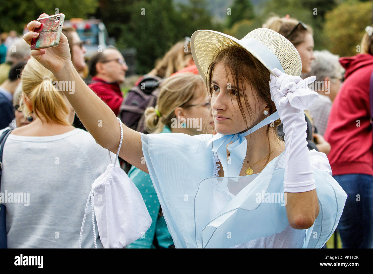 Bath, UK. 15th Sep, 2018. A Jane Austen fan is pictured taking a selfie as she prepares to take part in the world famous Grand Regency Costumed Promenade. The Promenade, part of the Jane Austen Festival is a procession through the streets of Bath and the participants who come from all over the world dress in 18th Century costume. Credit:  Lynchpics/Alamy Live News Stock Photo