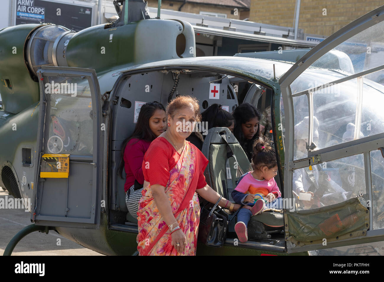 London 15th September 2018 UK Army open day to mark annual Saragarhi Commemorations This celebrates an epic battle where 21 Sikh soldiers took a last stand against 10,000 enemy tribesmen in 1897  A sikh family with an army air corp helicopter Credit Ian Davidson/Alamy Live News Stock Photo