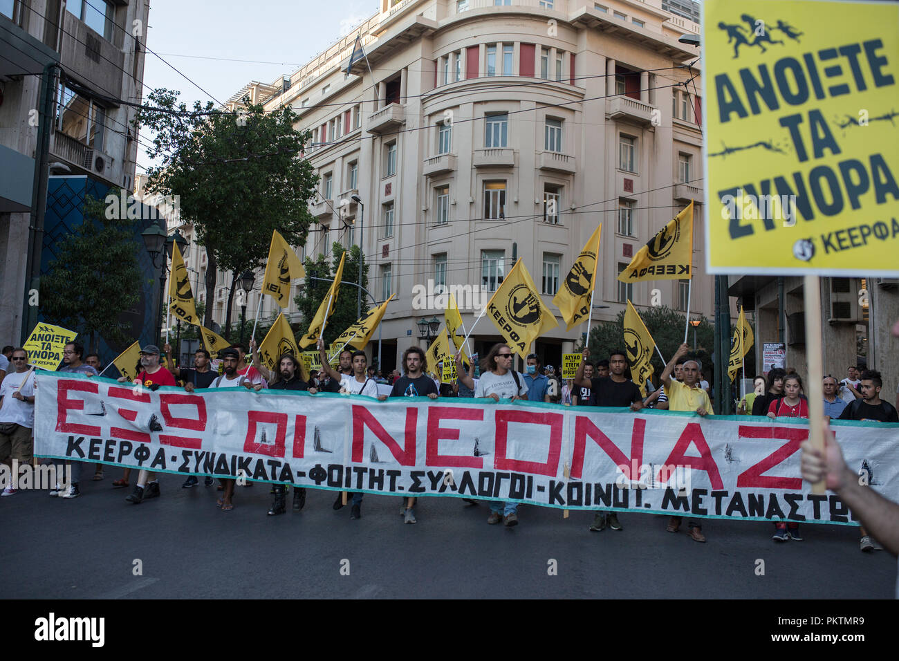 Athens, Greece. 15th Sep, 2018. 15 September 2018, Greece, Athens: Demonstrators are holding signs, flags and a banner with the inscription 'Neonazi out' on a march against racism and fascism. Thousands of people commemorated the murder of a rapper by a neo-Nazi in the port city of Piraeus five years ago on Saturday evening in central Athens and in other Greek cities. Credit: Socrates Baltagiannis/dpa/Alamy Live News Stock Photo