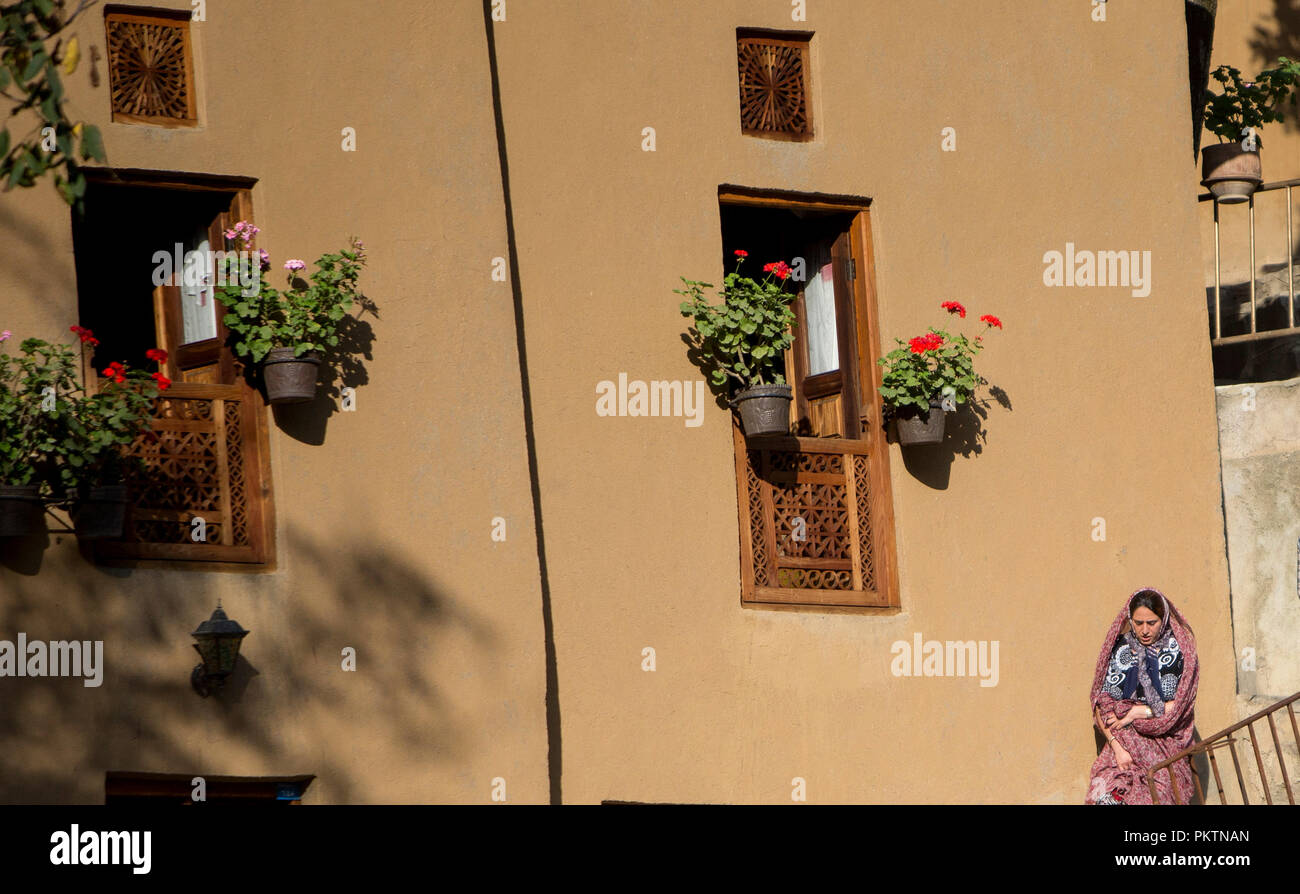 Masouleh, Iran. 14th Sep, 2018. A woman walks in Masouleh, northern Iran, on Sept. 14, 2018. The historical town of Masouleh, famous for its interconnected buildings and courtyards and roofs serving as pedestrian areas similar to streets, has an attractive nature and architecture with an antiquity of more than 1,000 years. Credit: Ahmad Halabisaz/Xinhua/Alamy Live News Stock Photo