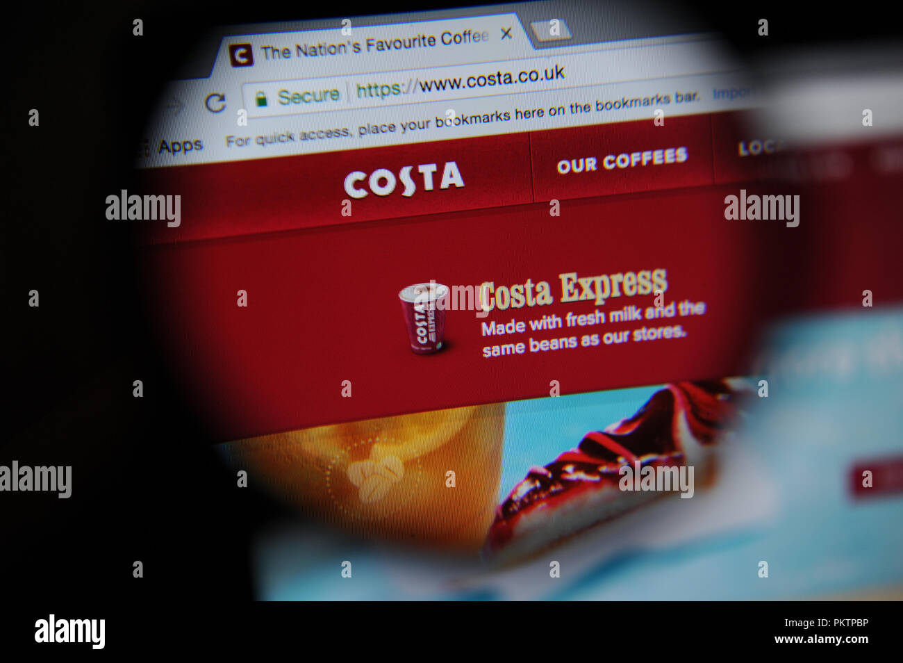 The Costa Costa website seen through a magnifying glass Stock Photo