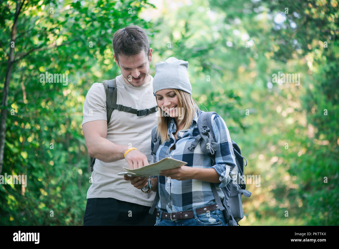 Hiking couple with map Stock Photo - Alamy