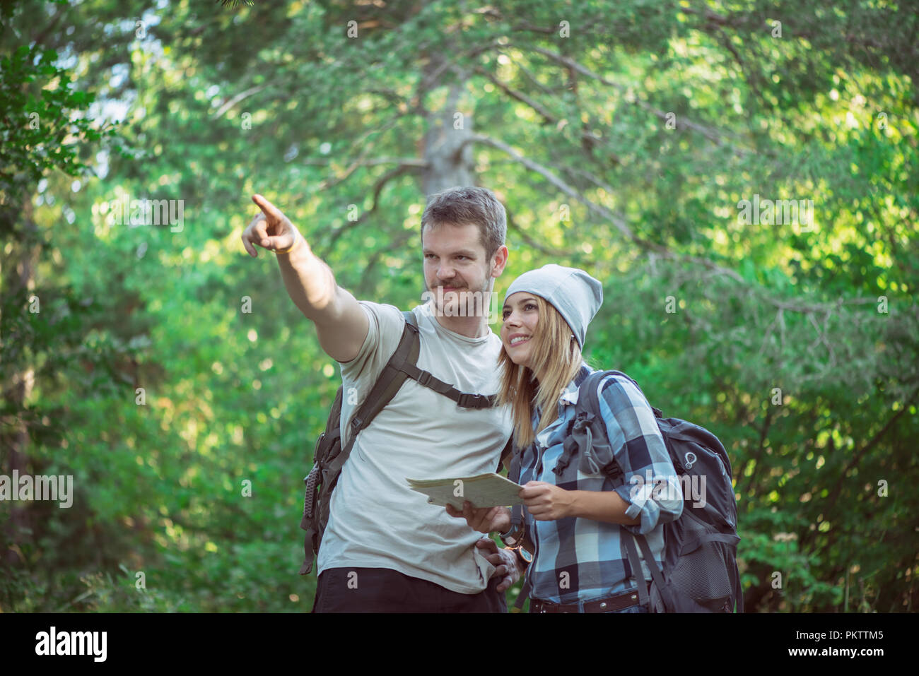Hiking couple with map Stock Photo - Alamy
