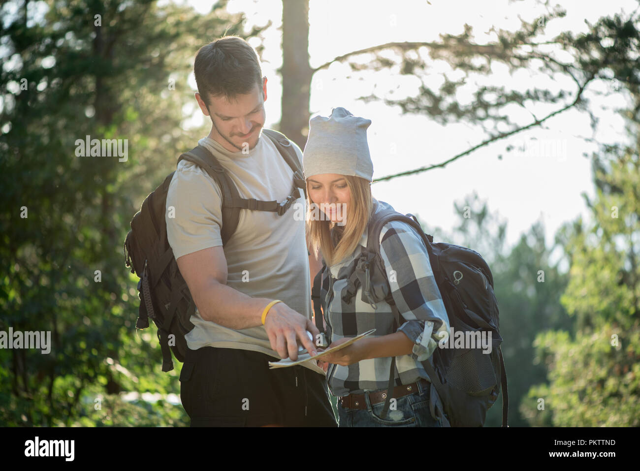 Hiking couple with map Stock Photo - Alamy