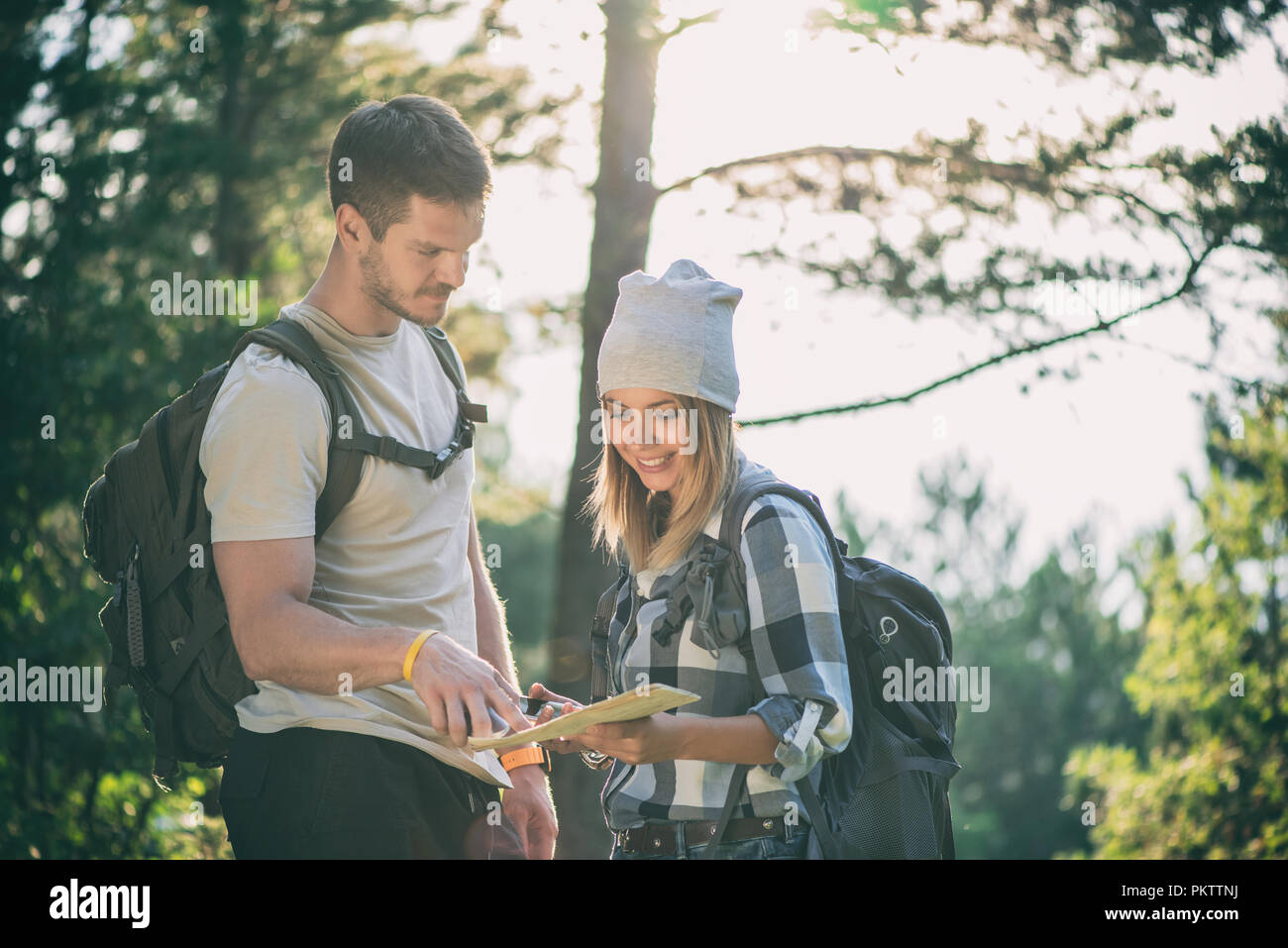 Hiking couple with map Stock Photo - Alamy