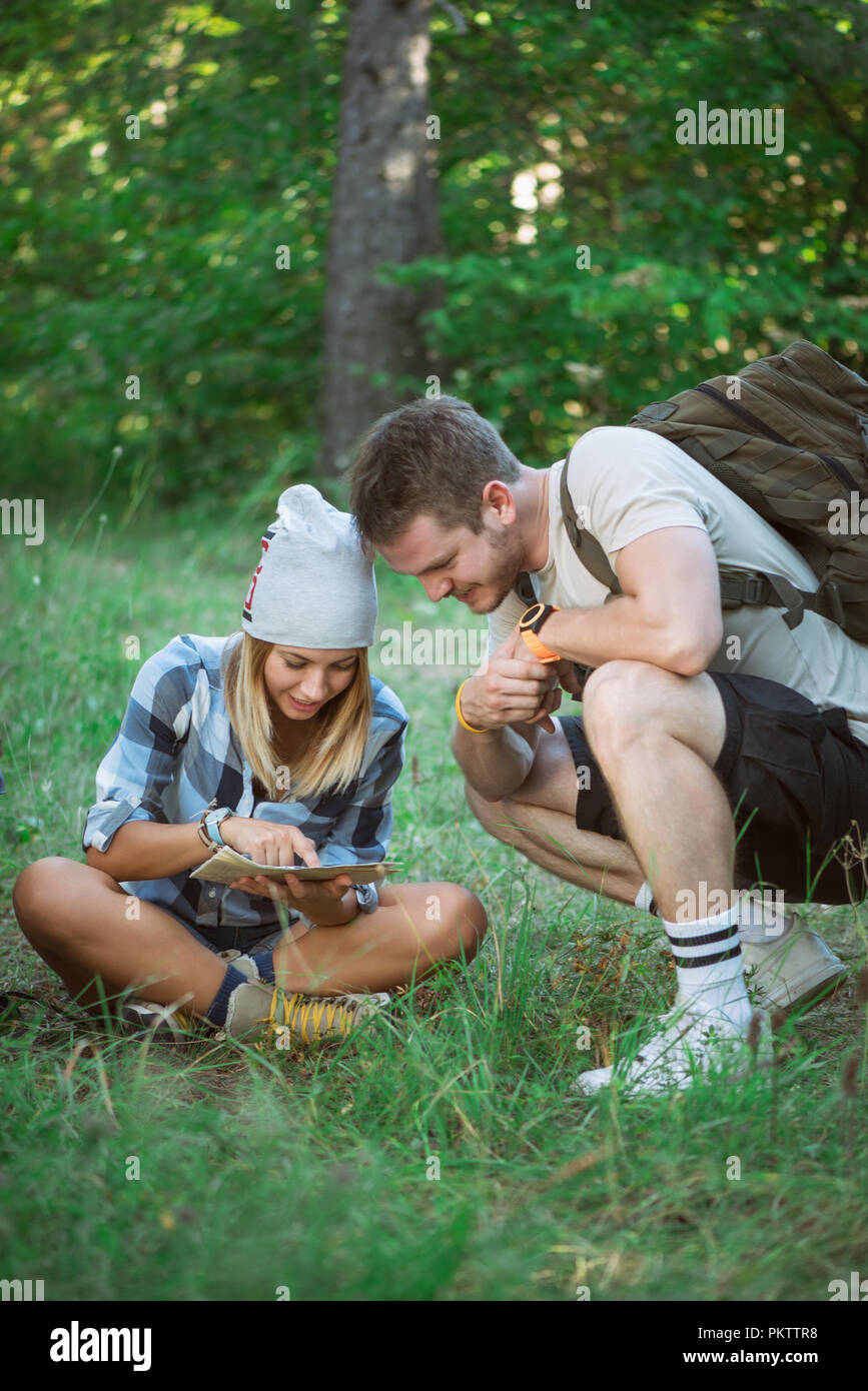 Hiking couple with map Stock Photo - Alamy