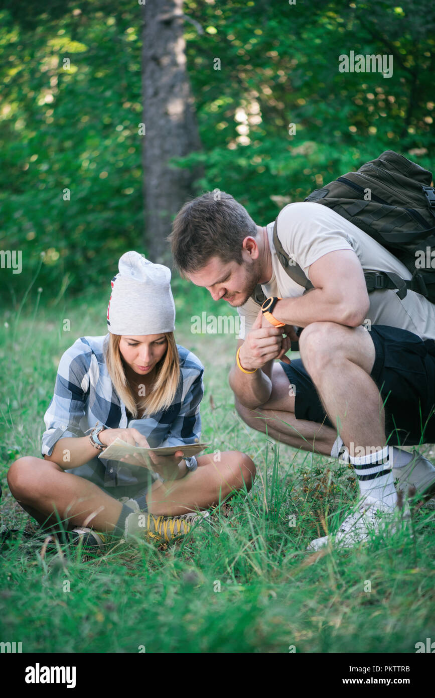 Hiking couple with map Stock Photo - Alamy