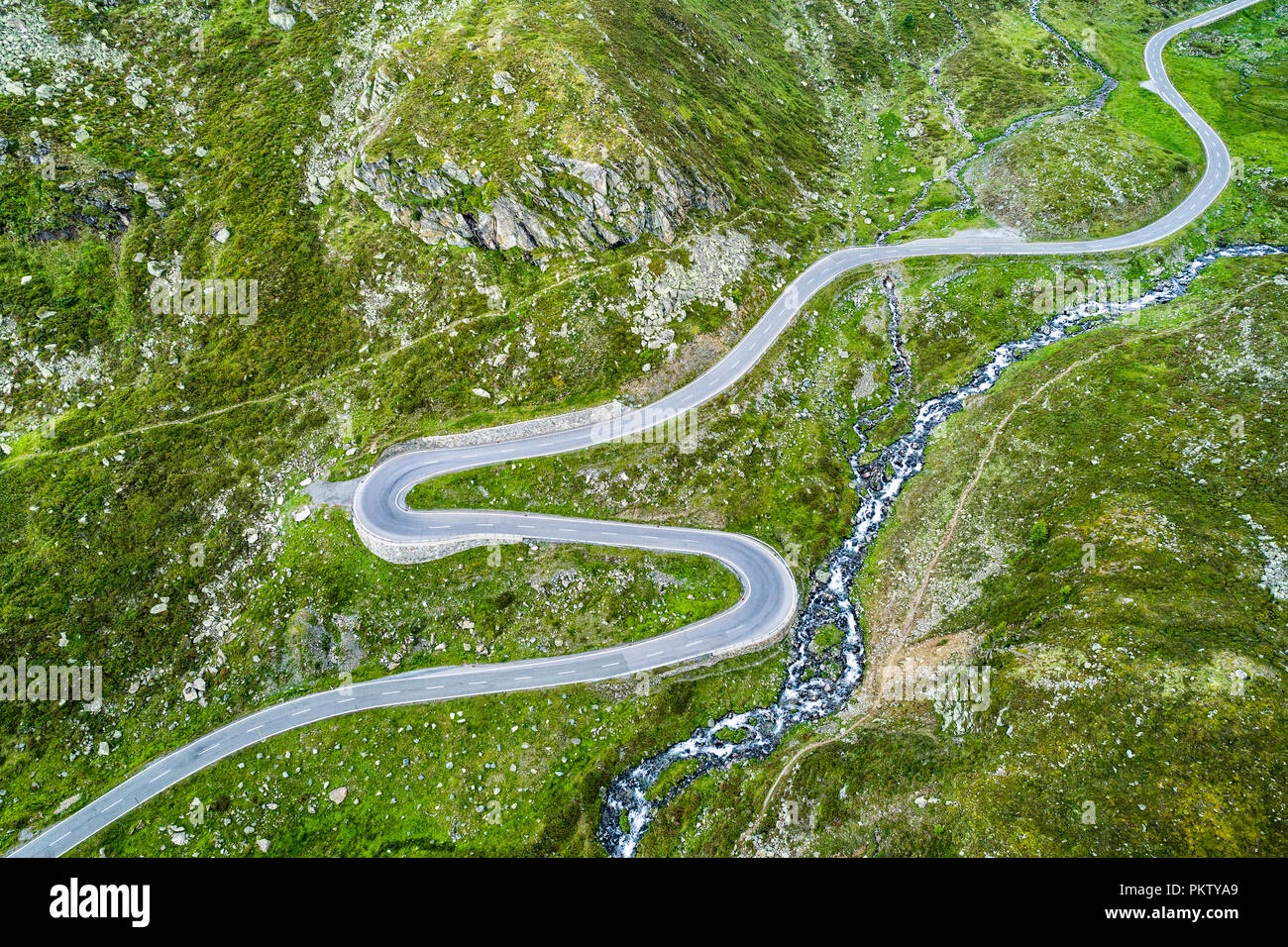 Aerial view, curvy mountain pass road Flüelapass, with clouds, canton of Grisons, Switzerland Stock Photo
