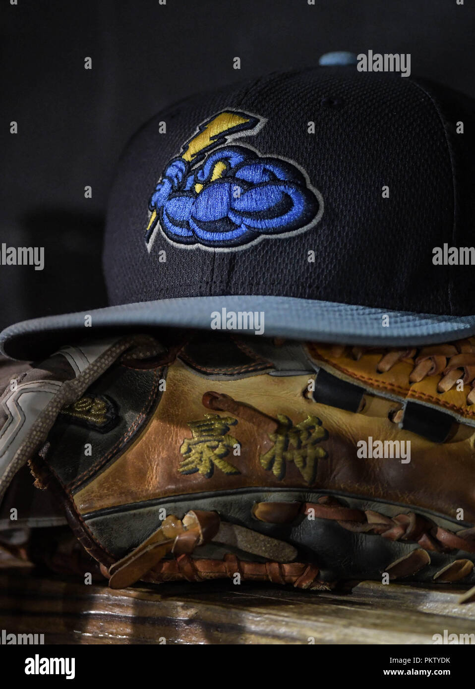 A baseball cap and glove in the dugout of the Trenton Thunder, the New York  Yankees' minor league affiliate, during a playoff game Stock Photo - Alamy