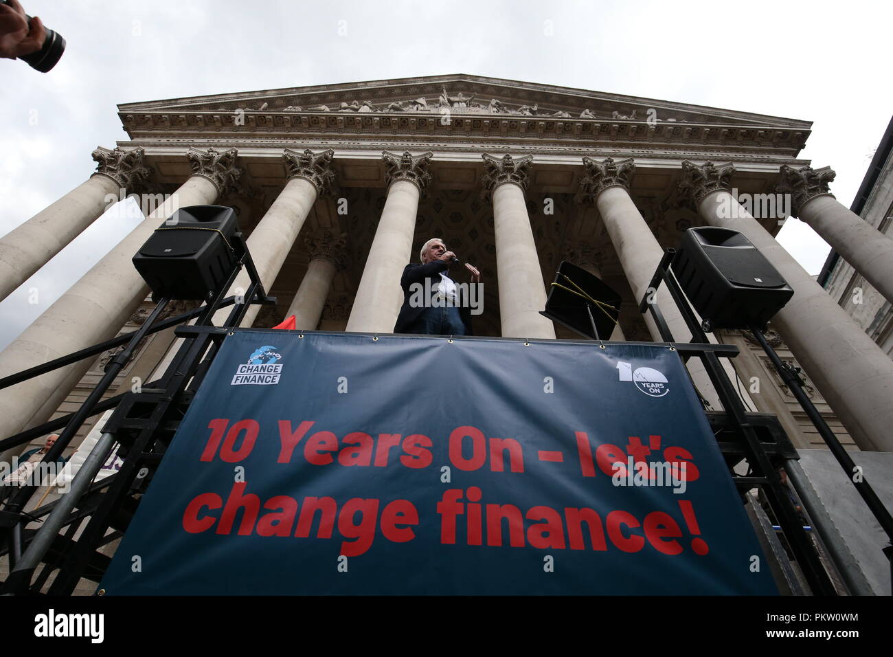 Shadow Chancellor John McDonnell speaking at a rally to mark the 10th anniversary of the collapse of Lehman Brothers and the financial crisis, outside the Royal Exchange building in the City of London. Stock Photo