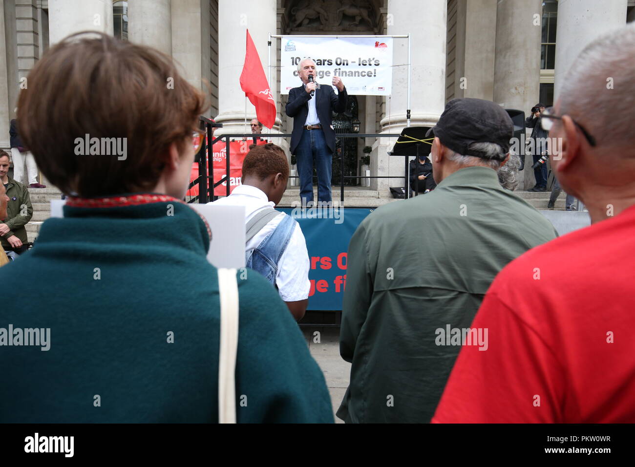 Shadow Chancellor John McDonnell speaking at a rally to mark the 10th anniversary of the collapse of Lehman Brothers and the financial crisis, outside the Royal Exchange building in the City of London. Stock Photo