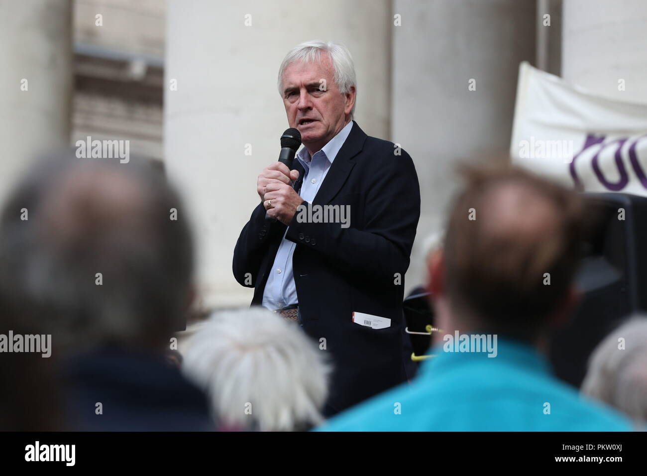 Shadow Chancellor John McDonnell speaking at a rally to mark the 10th anniversary of the collapse of Lehman Brothers and the financial crisis, outside the Royal Exchange building in the City of London. Stock Photo