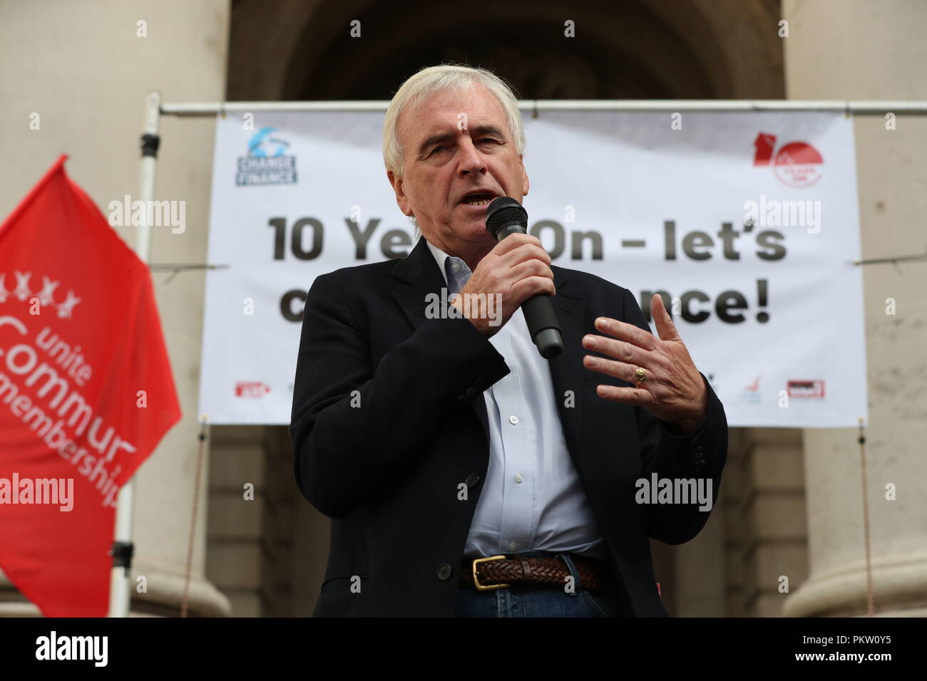 Shadow Chancellor John McDonnell speaking at a rally to mark the 10th anniversary of the collapse of Lehman Brothers and the financial crisis, outside the Royal Exchange building in the City of London. Stock Photo