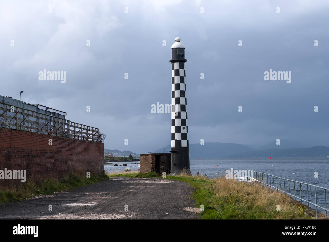 The old West Quey Beacon Light house sits on the west Quey of Port Glasgow Stock Photo