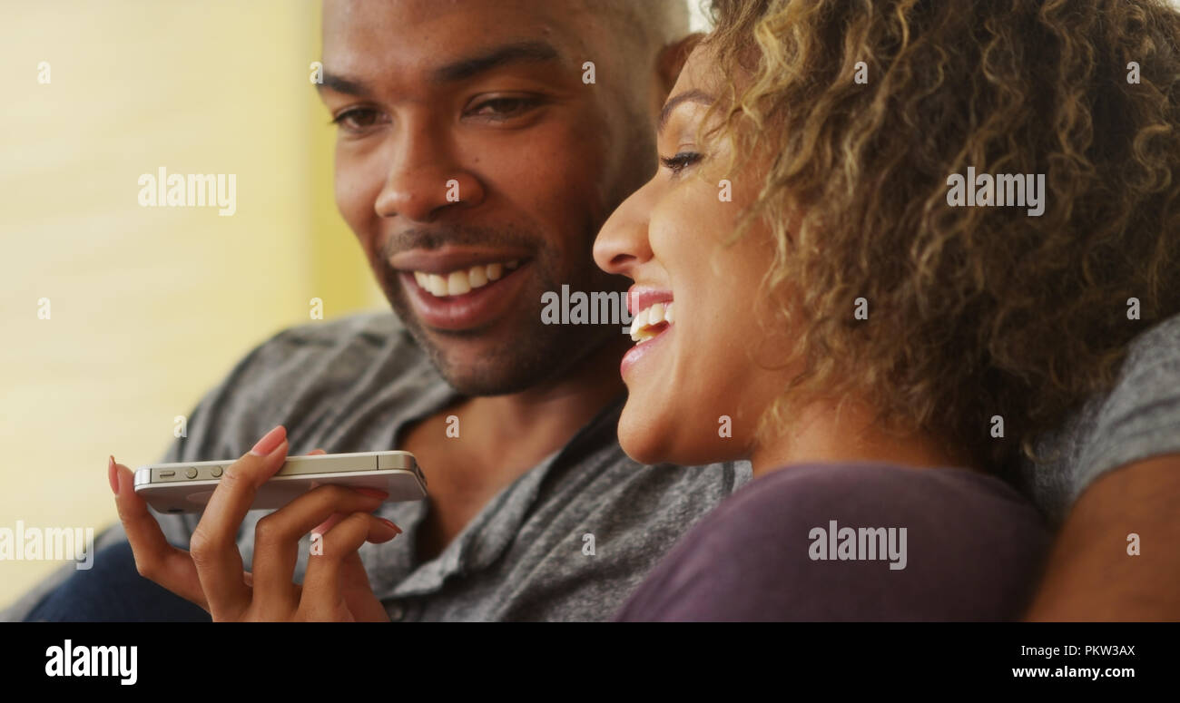 Black couple talking on smartphone Stock Photo