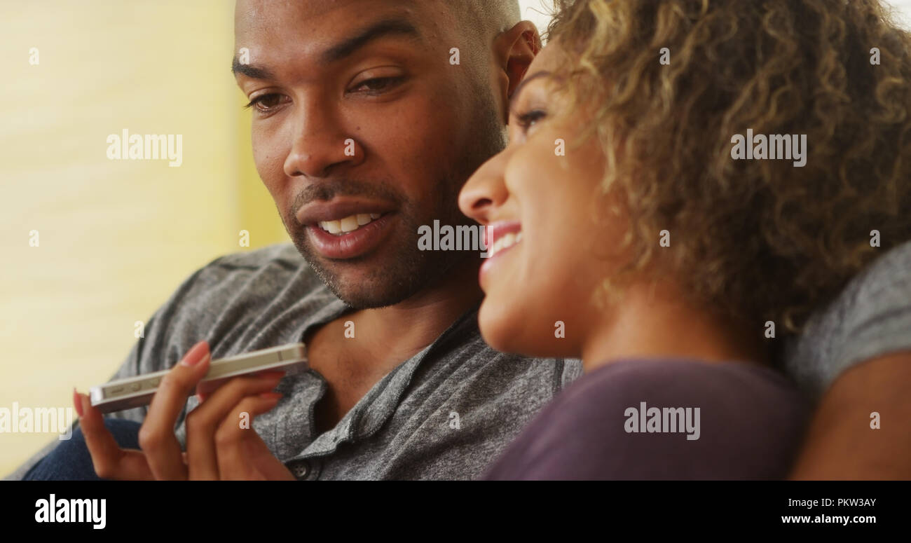 African couple talking on smartphone Stock Photo