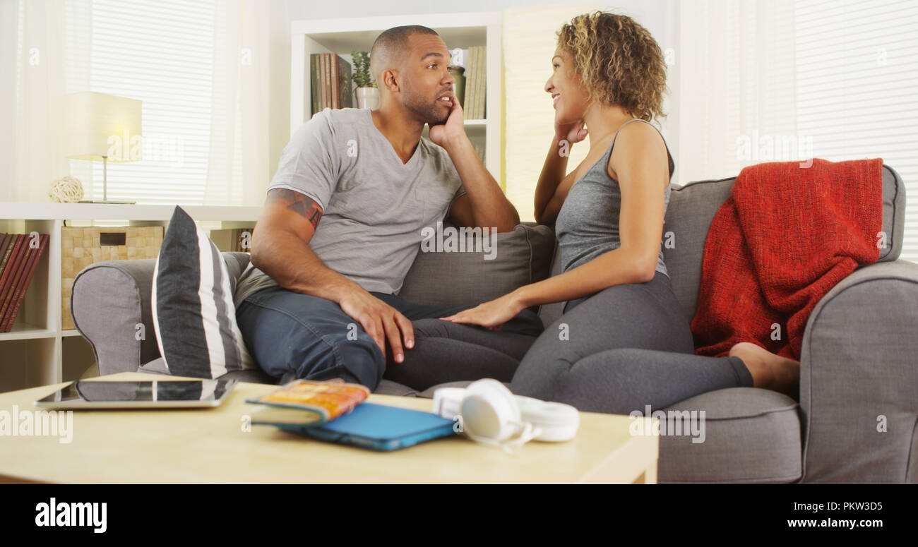 African American couple talking together on couch Stock Photo - Alamy