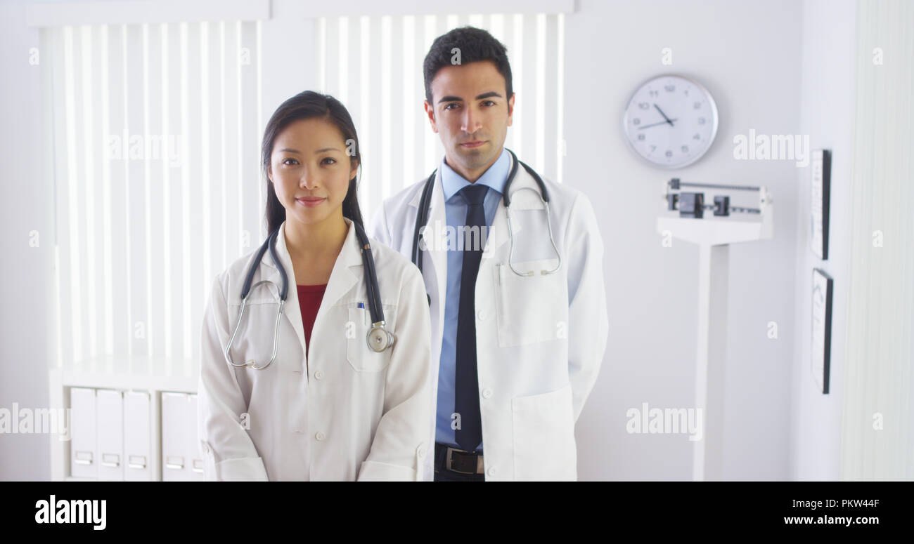 Happy doctors standing in office Stock Photo