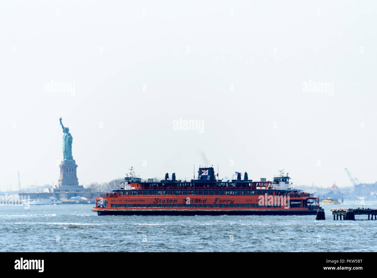 04-2018 New York, USA. Photographed through a heat haze, the Staten Island Ferry passes the Statue of Liberty. Photo: © Simon Grosset Stock Photo