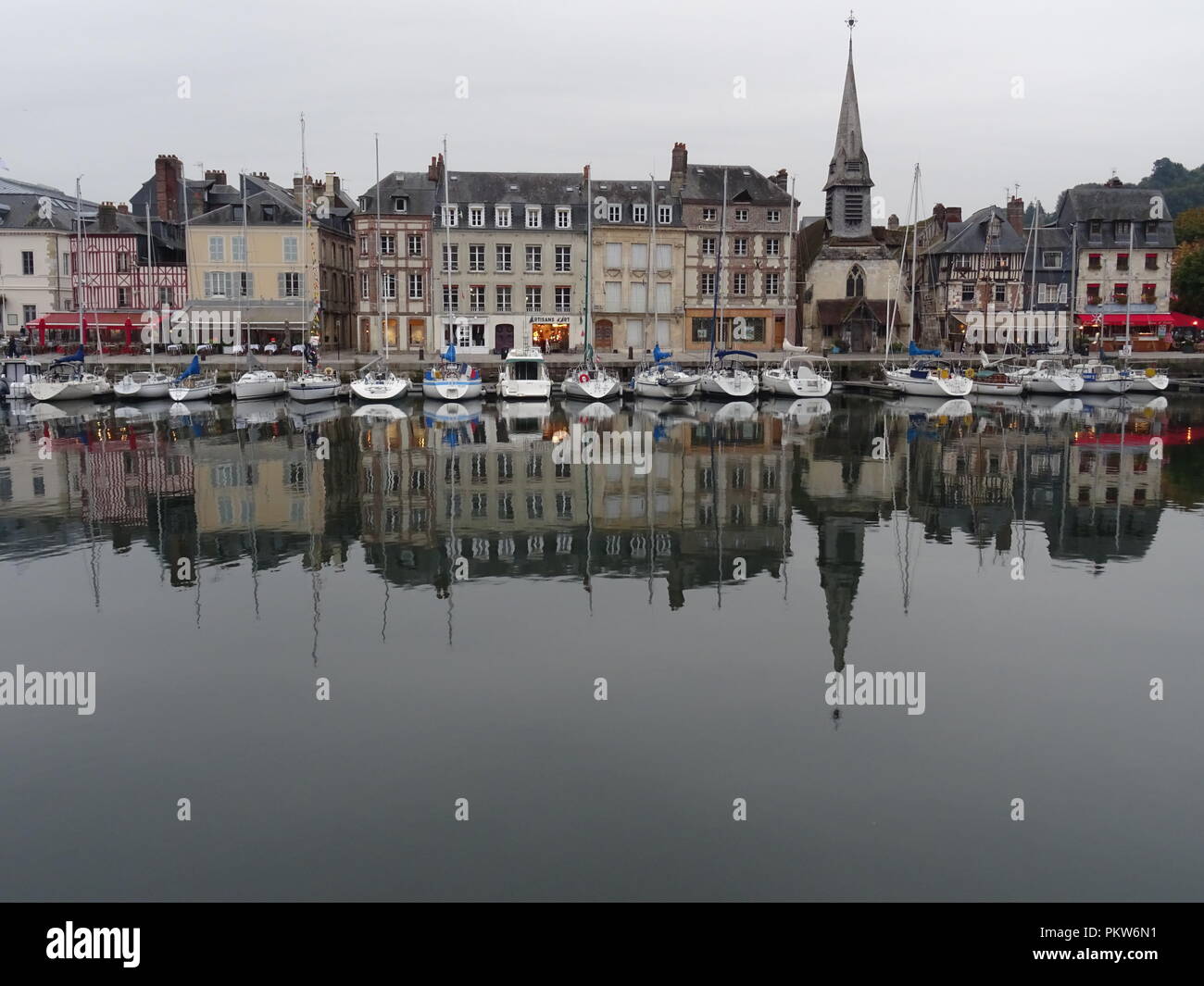 Mirror reflection in the old harbor of the small french town of