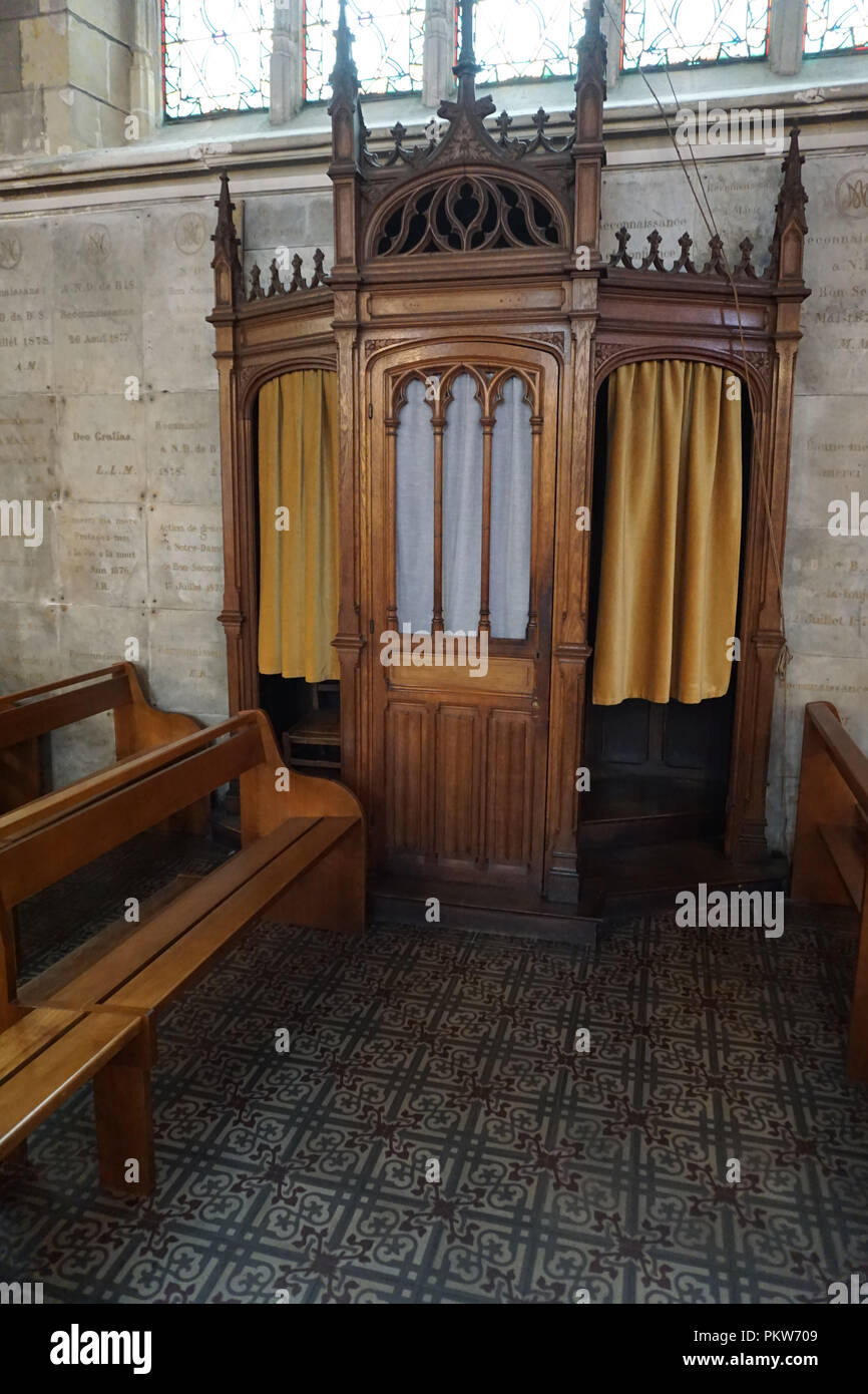 Old fashion wood confessional inside the church with beautiful, colorful tile floor Stock Photo