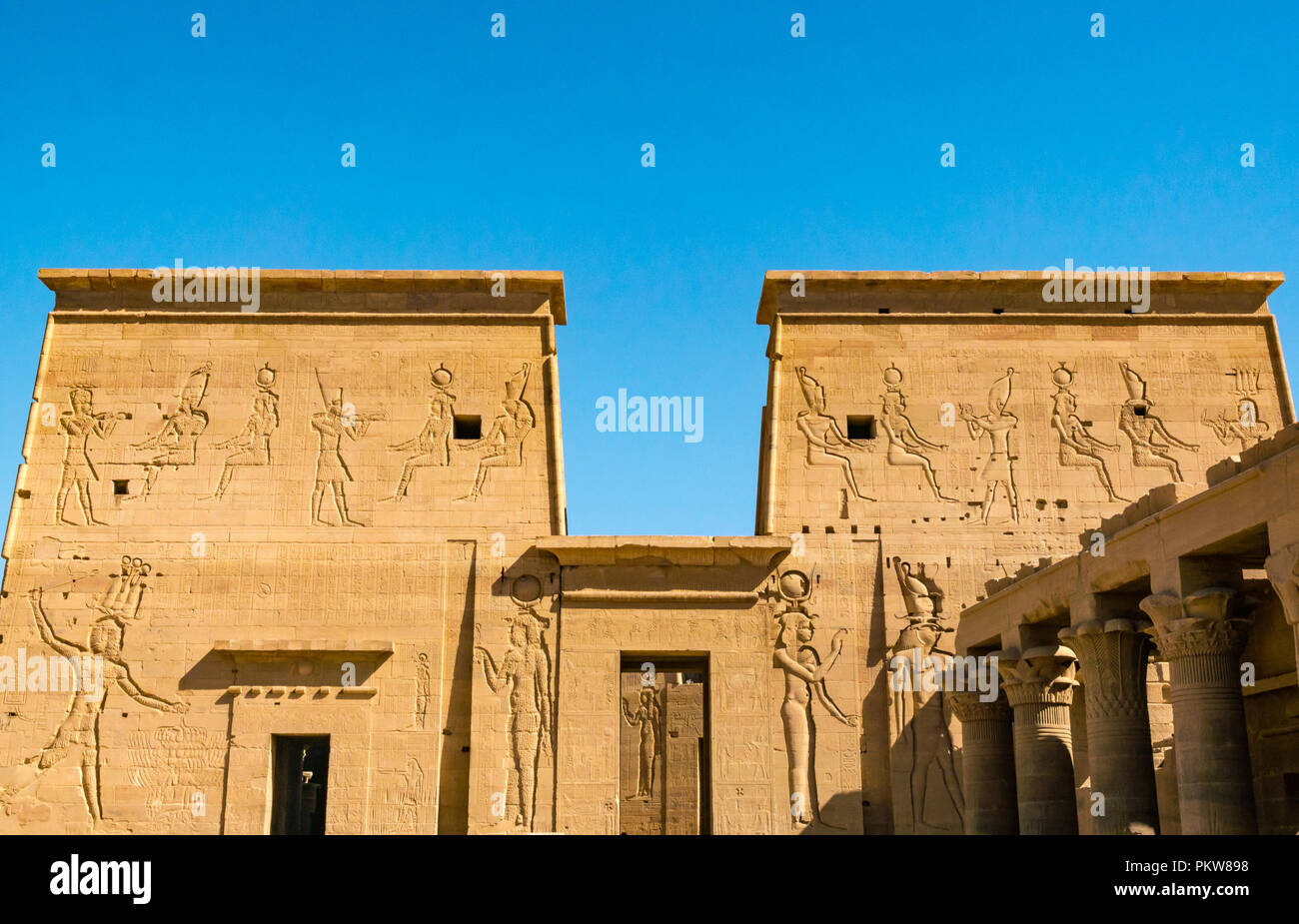 Outer pylon walls with carved Egyptian figures and hieroglyphs, Temple of Philae, Agilkia Island, River Nile, Aswan, Egypt, Africa Stock Photo