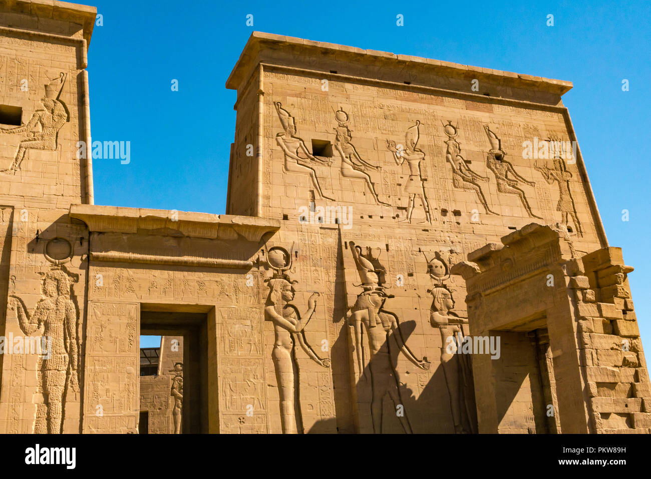 Outer pylon walls with carved Egyptian figures and hieroglyphs, Temple of Philae, Agilkia Island, River Nile, Aswan, Egypt, Africa Stock Photo