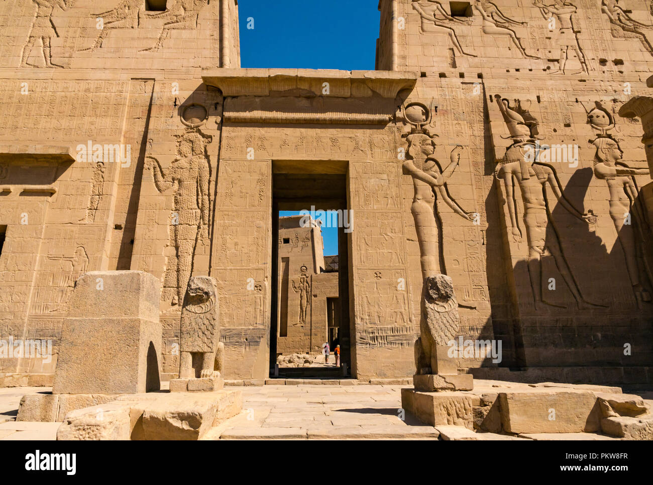 Outer pylon and gateway with carved Egyptian figures and hieroglyphs, Temple of Philae, Agilkia Island, River Nile, Aswan, Egypt, Africa Stock Photo