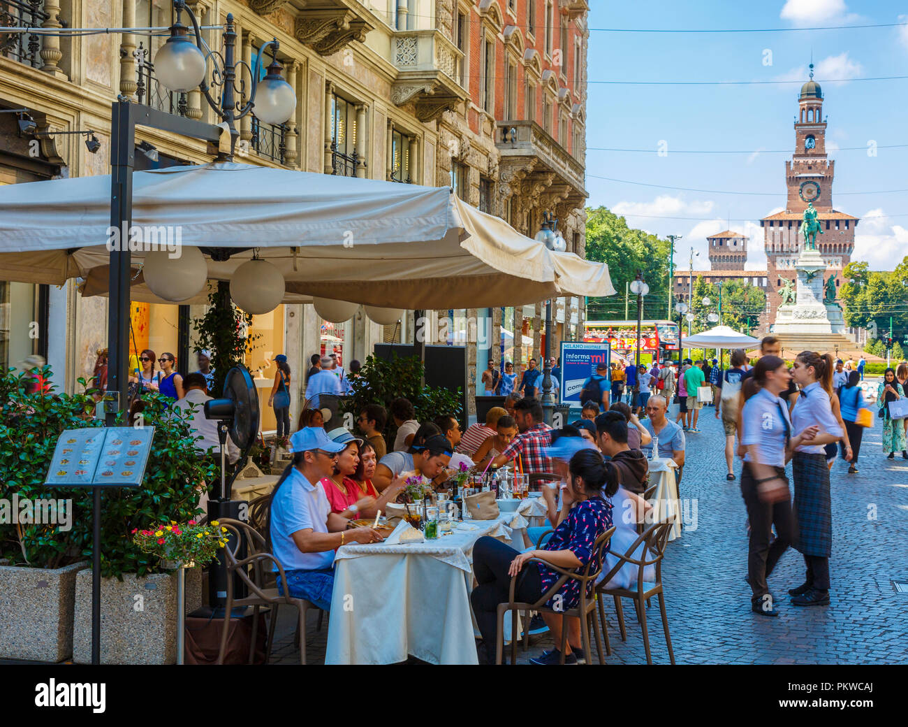 Pavement cafe in Dante street and Sforza Castle. Stock Photo