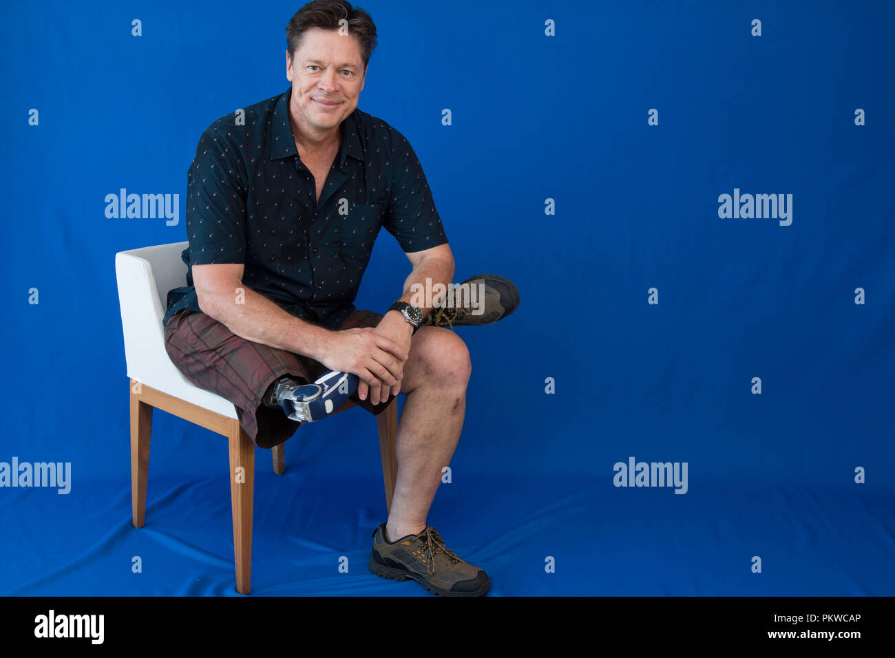 Handicapped man sitting in a chair Stock Photo