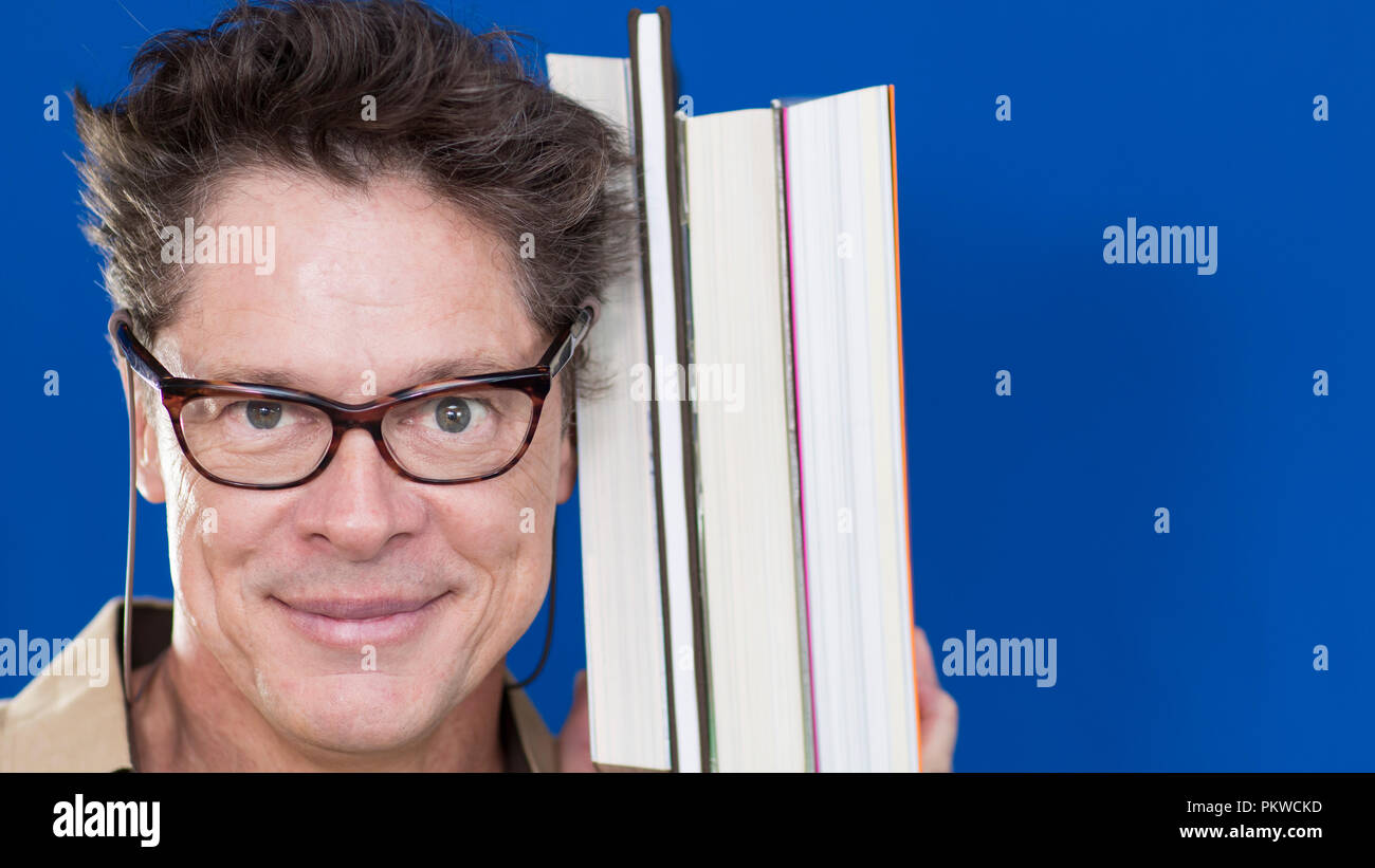 Mature teacher holding glasses hi-res stock photography and images - Alamy