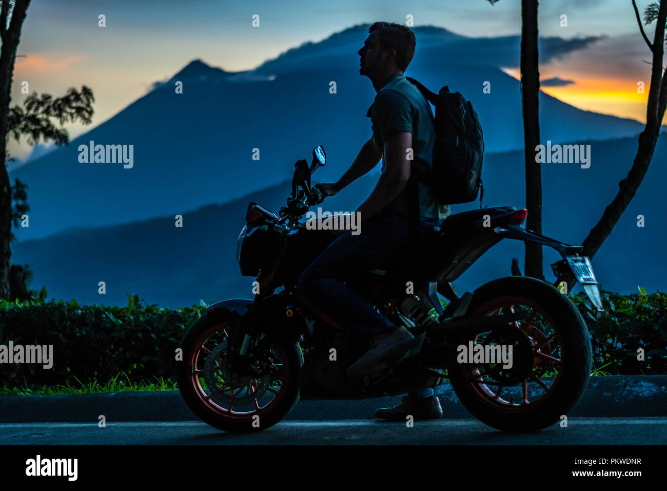 man on motorcycle with volcano in the background Stock Photo - Alamy