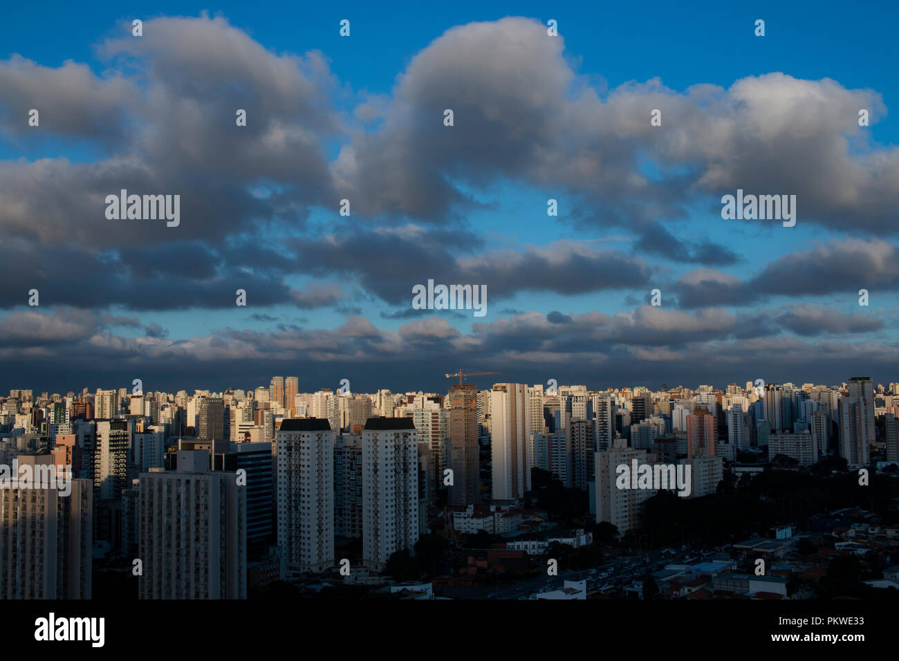 Sky with clouds over the evening city with sunset. Sao Paulo city, Brazil South America. Stock Photo