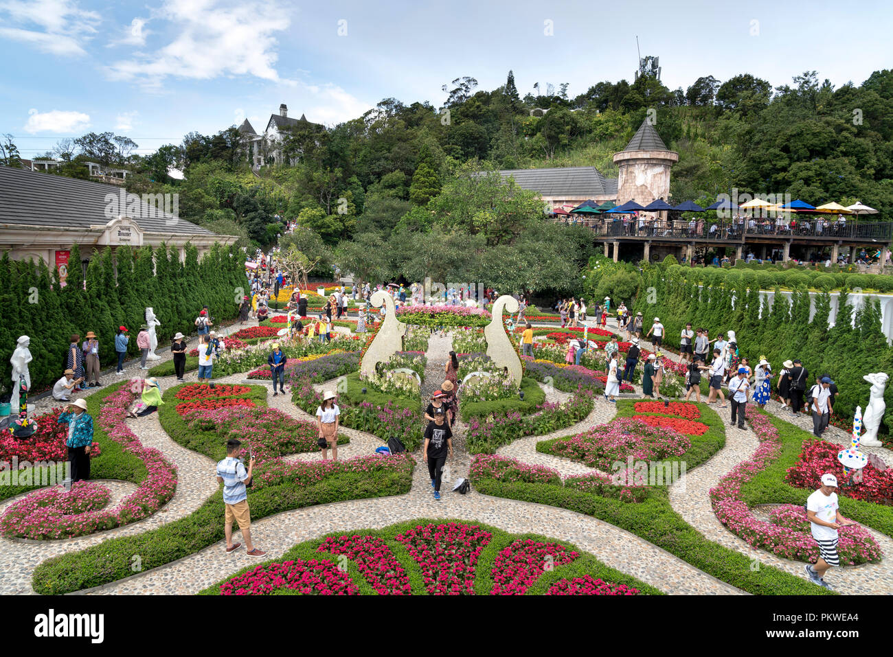 Tourists visit the beautiful flower garden of Ba Na Hill. Ba Na Hill mountain resort is a favorite destination for many tourists Stock Photo