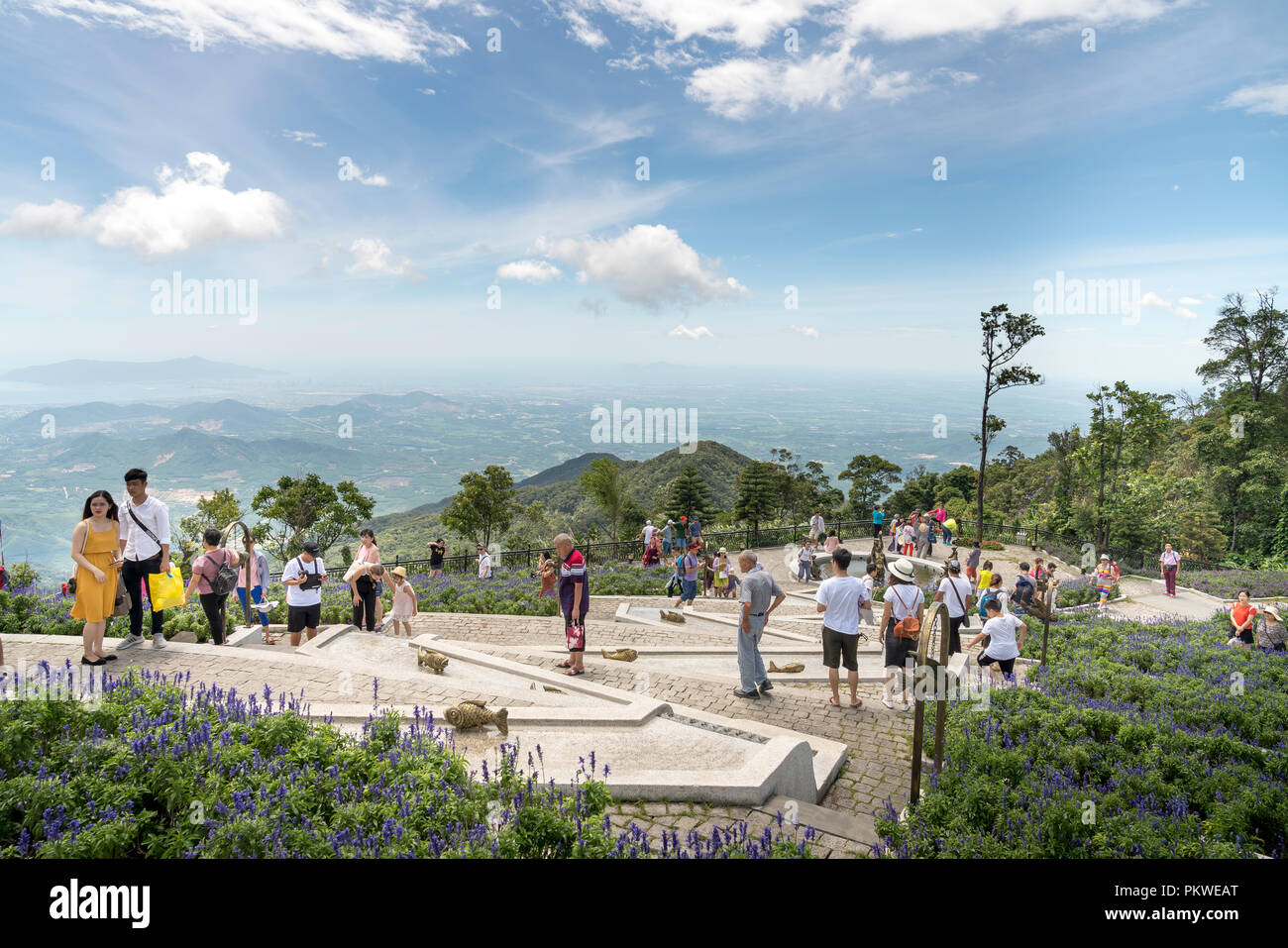 Tourists visit the beautiful flower garden of Ba Na Hill. Ba Na Hill mountain resort is a favorite destination for many tourists Stock Photo