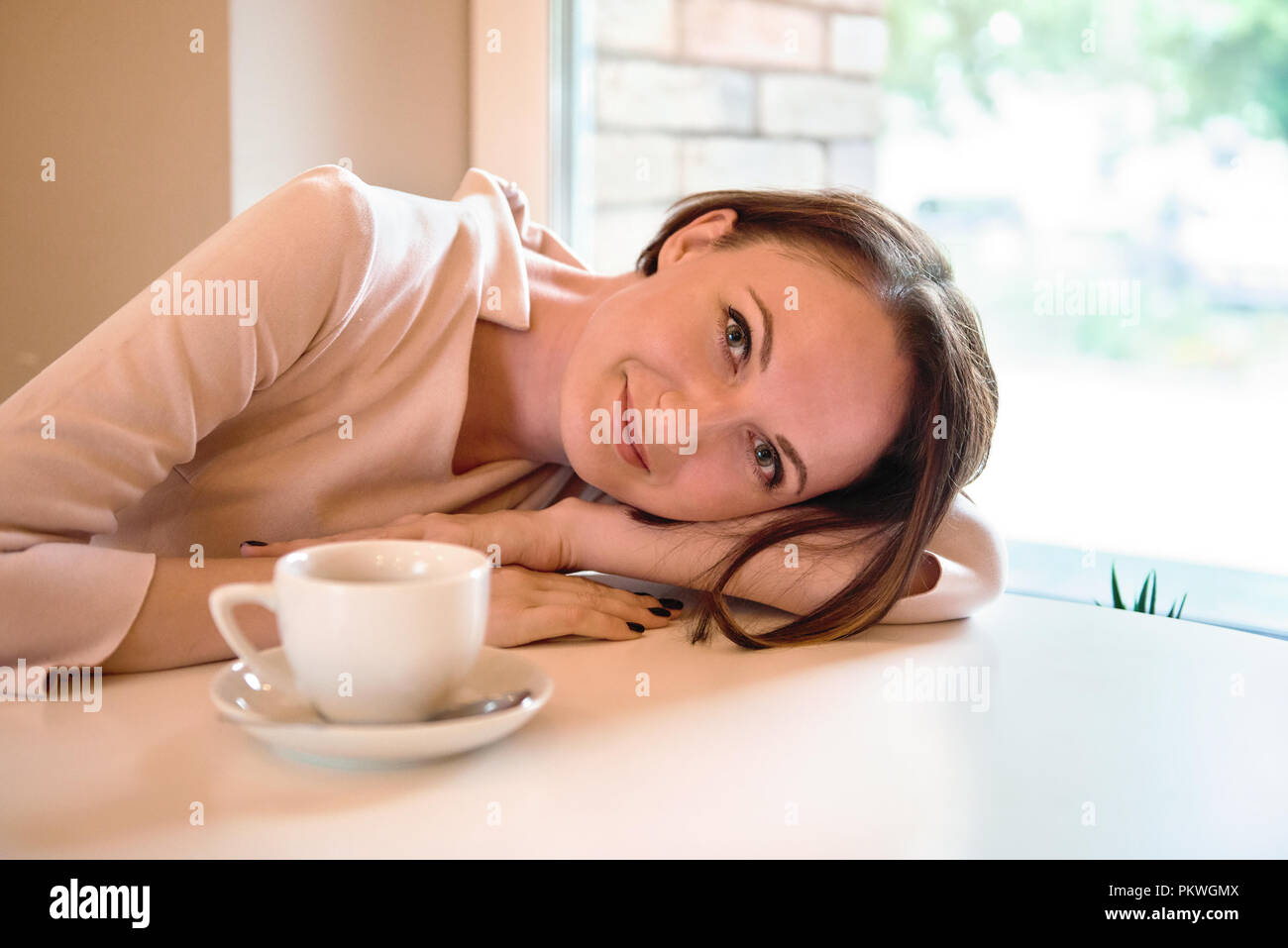 portrait of a young woman in a cafe Stock Photo - Alamy
