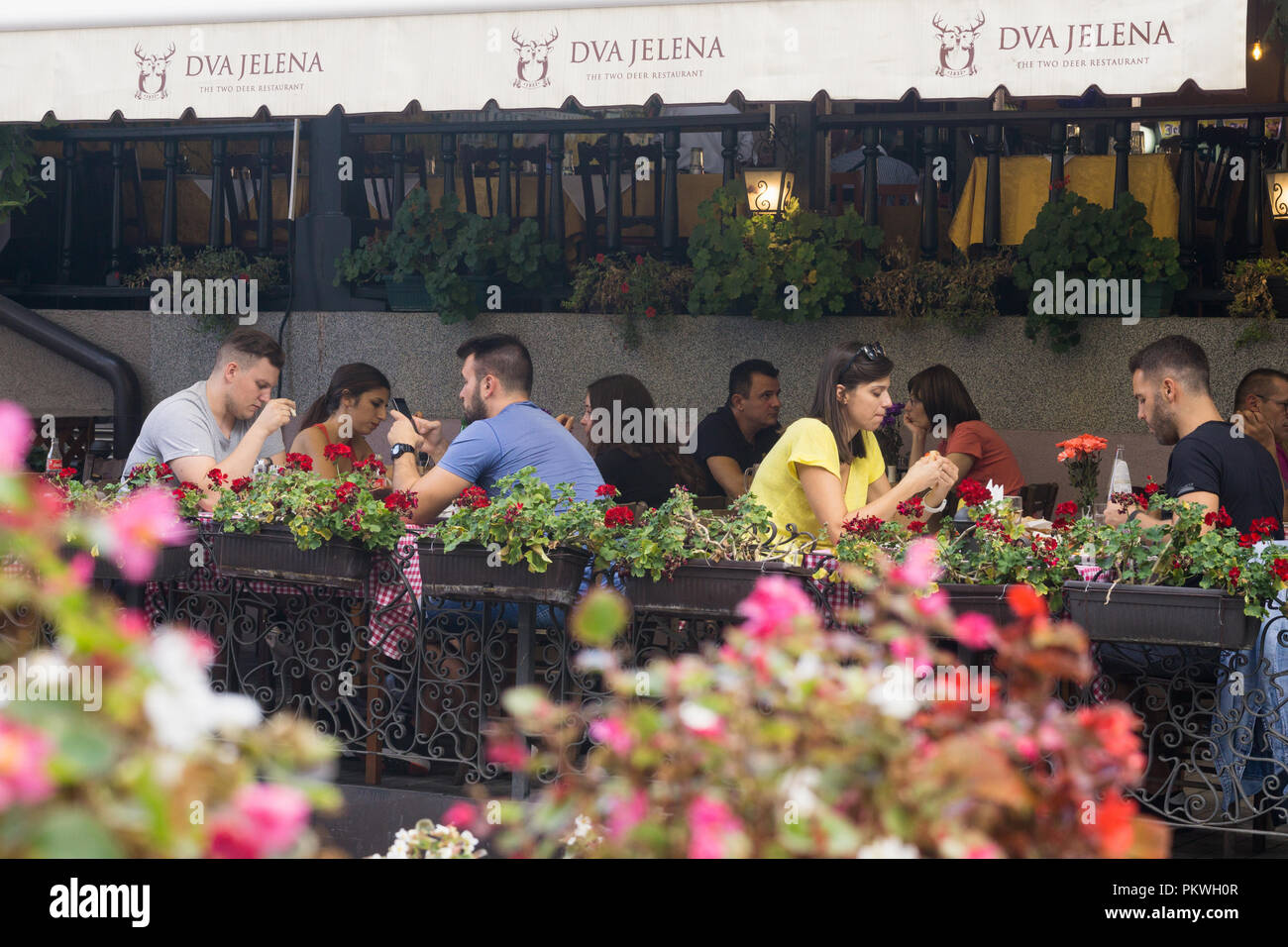 People having lunch at Dva Jelena restaurant in the bohemian quarter on Skadarska street in Belgrade, Serbia. Stock Photo