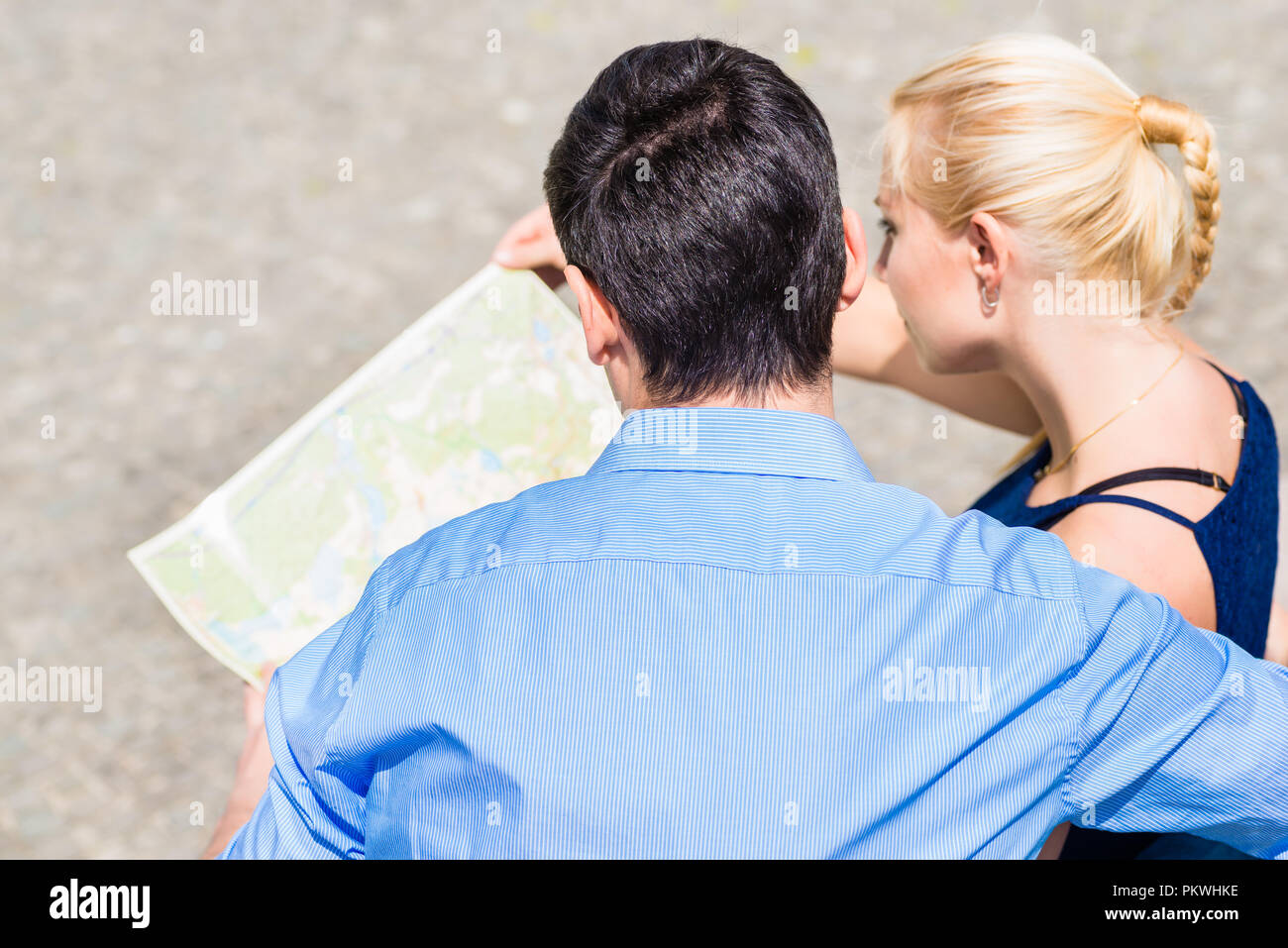 An overhead view of couple looking at map Stock Photo
