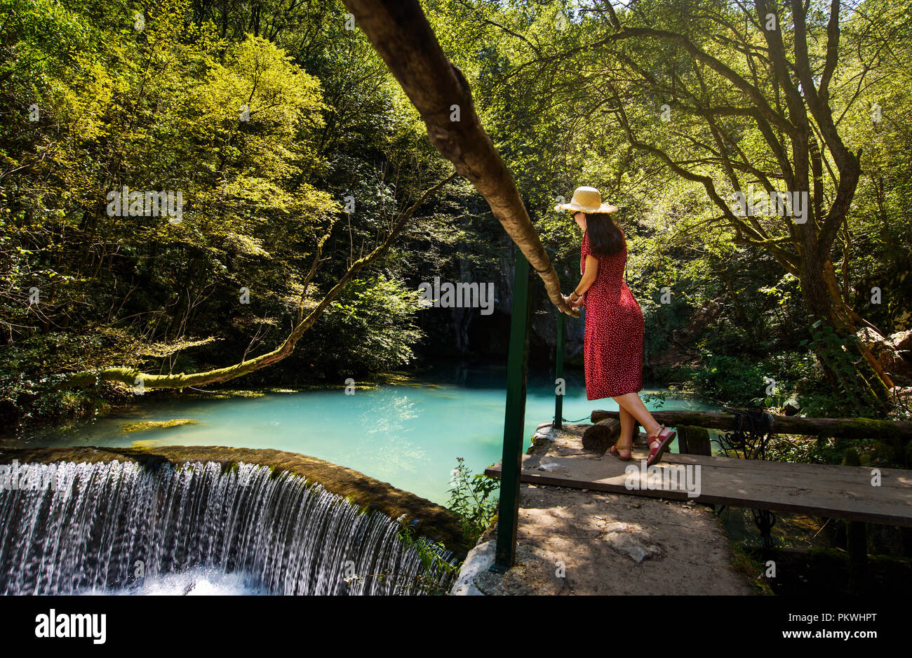 Girl enjoying day outdoors at a natural water well Stock Photo