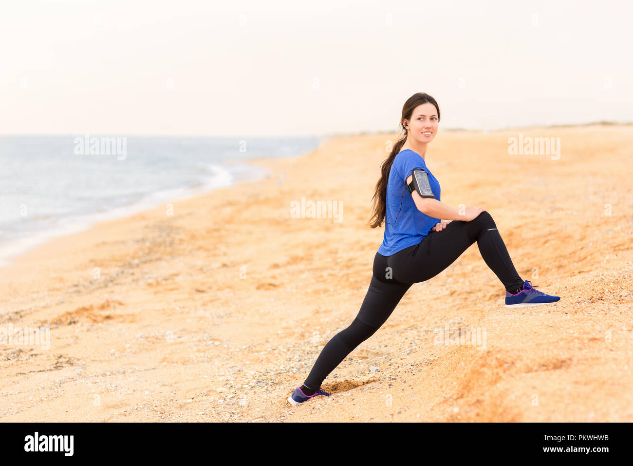 woman doing stretch exercises on the sea beach Stock Photo Alamy