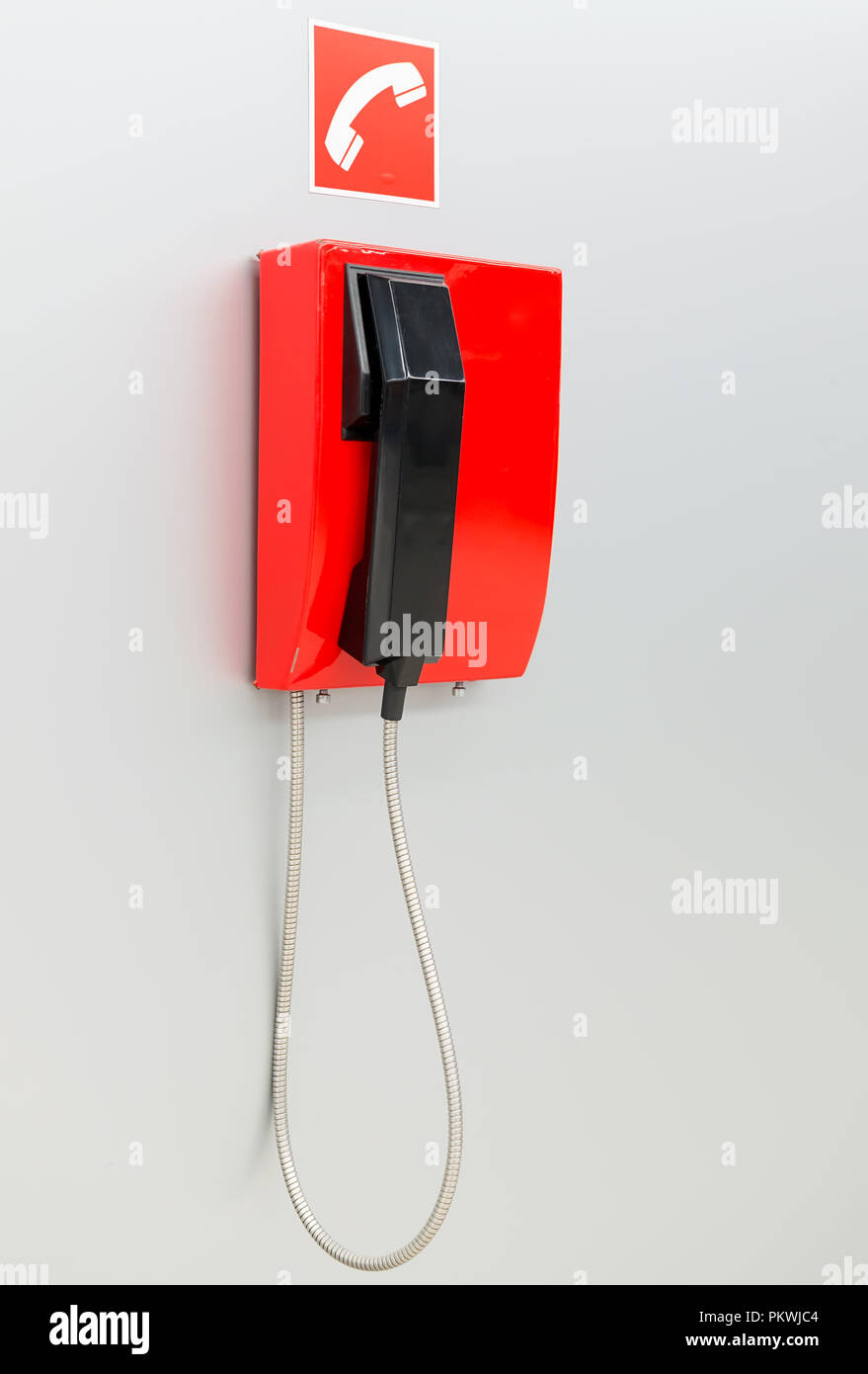 Red vintage telephone hanging on white wall Stock Photo Alamy