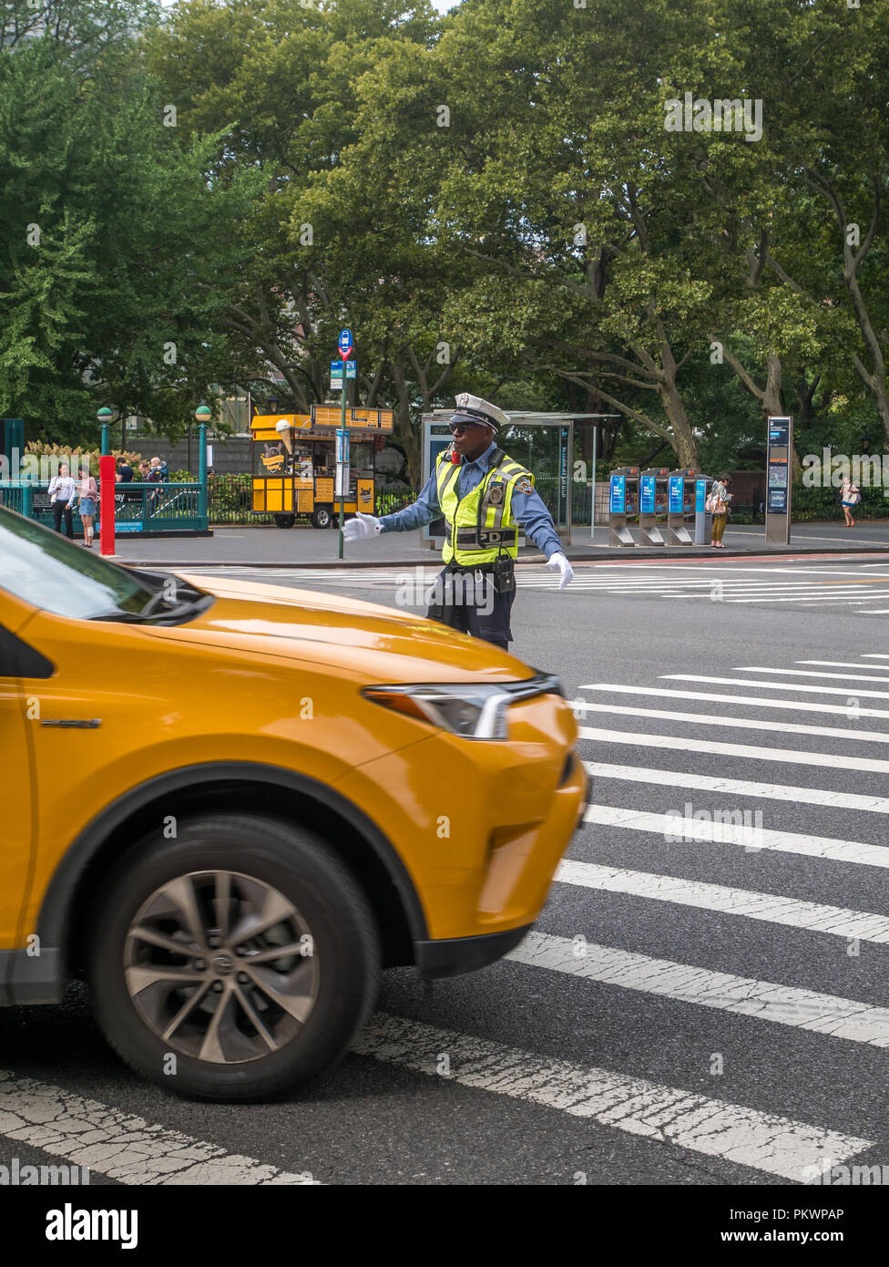 New York City, USA - September 8, 2018: Traffic police man is directing cars on roads in New York City. Stock Photo