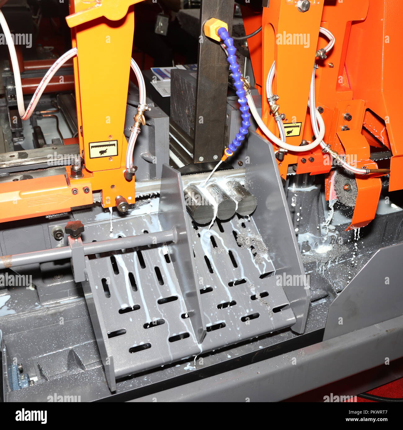 Steel bar cutting by band saw machine with coolant Stock Photo Alamy